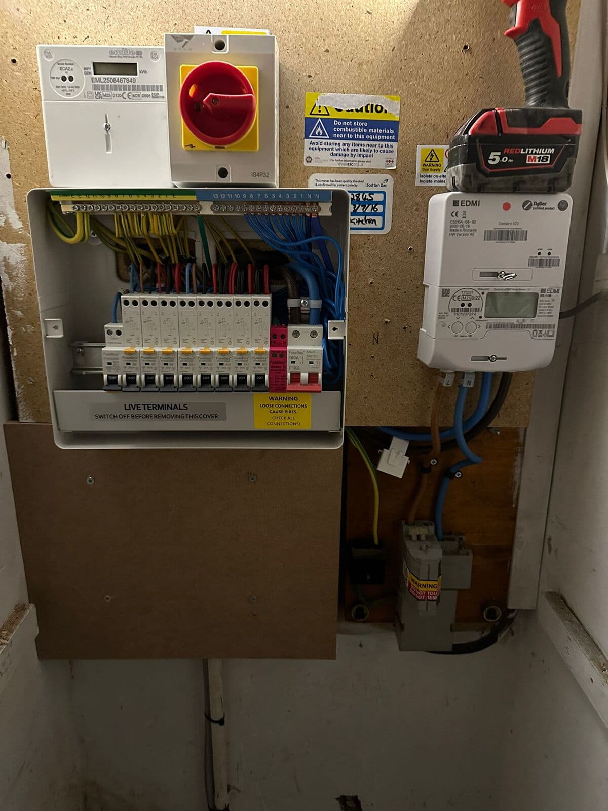 New consumer unit and red isolator switch fitted on a board
