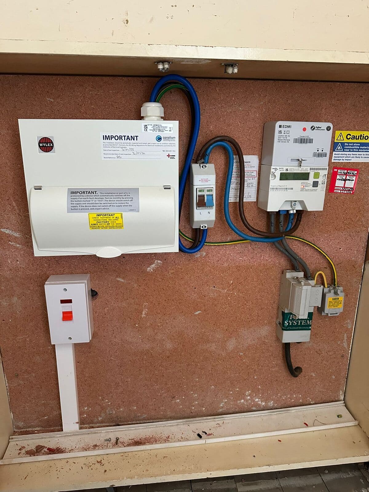 Consumer unit, isolator and meter fitted on a red board