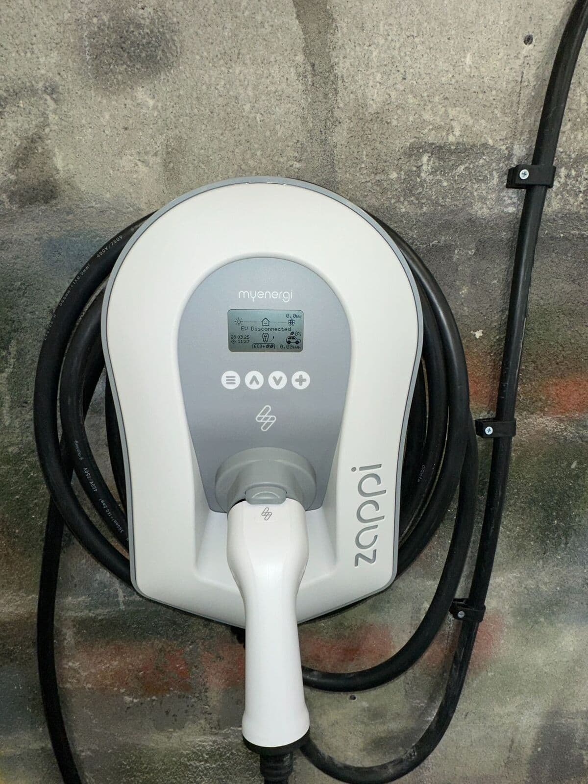 White zappi home car charger on a stone wall